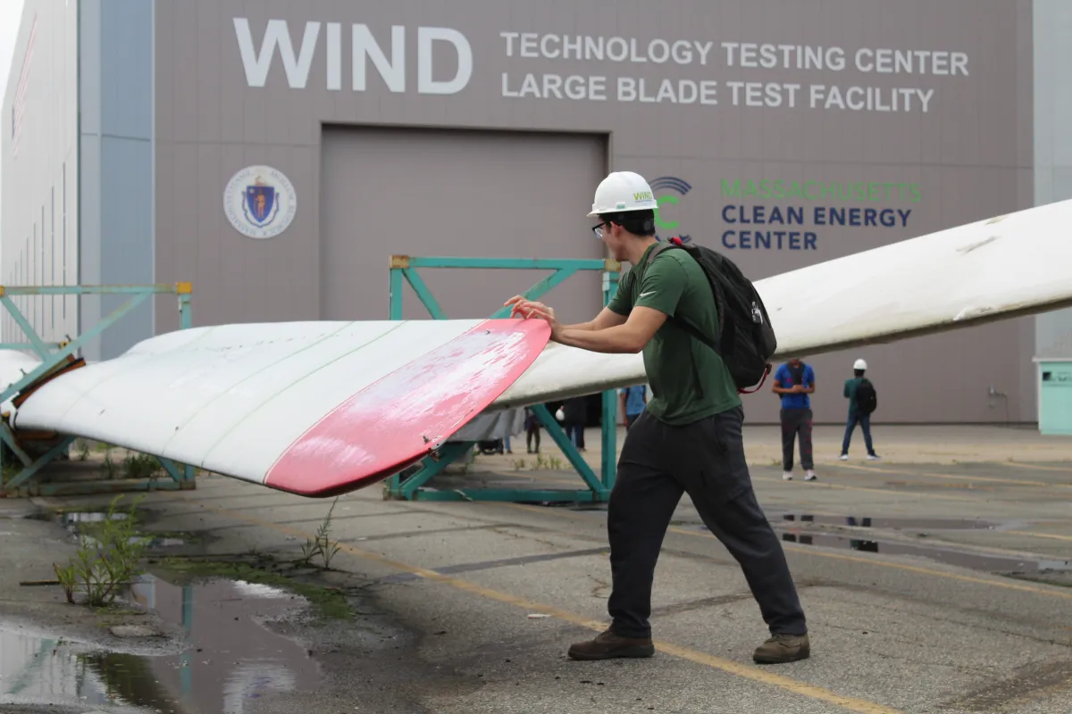 Student investigates wind turbine blade.