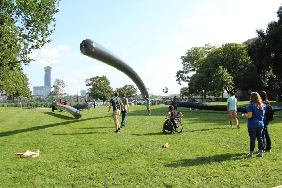 Students play with balloons on MIT campus.