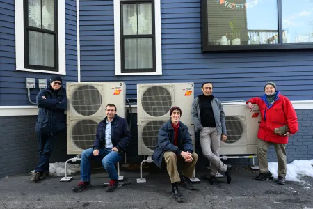 MIT researchers pose with home air conditioning system.