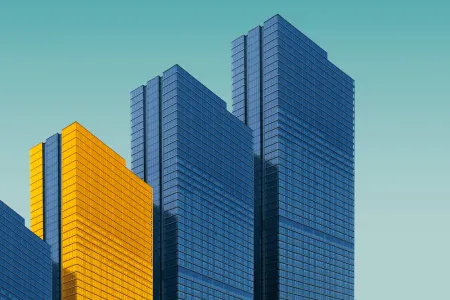 Buildings in a row with one light by sun.