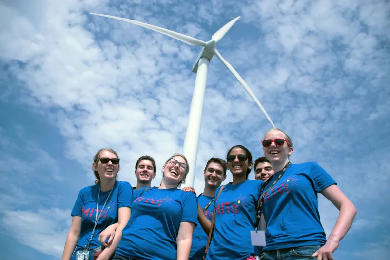 First-year Preorientation Program students with a wind turbine.