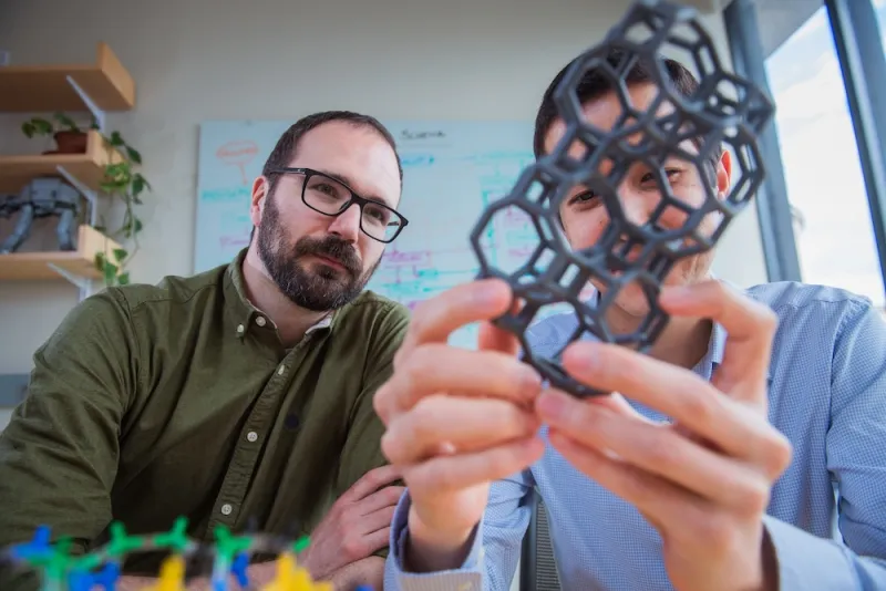 Professor Rafael Gómez-Bombarelli and Daniel Schwalbe-Koda with model of zeolite