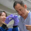Professor Ju Li (right) and postdoc So Yeon Kim examine samples of the composite they have fabricated for their demonstrations