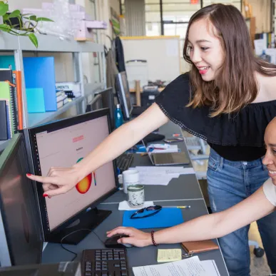 MIT students work together at a computer.