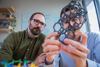 Professor Rafael Gómez-Bombarelli and Daniel Schwalbe-Koda with model of zeolite