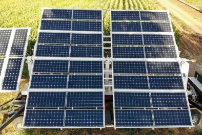 A high-angle shot of a transportable solar microgrid on grass