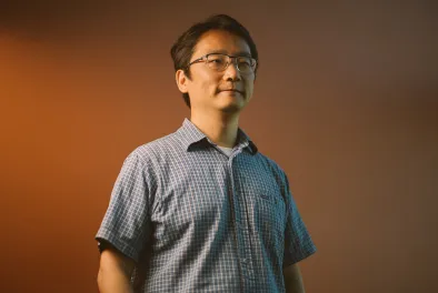 Photo of MIT faculty member Andy Sun photographed from the waist up